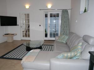 a living room with a white couch and a glass table at Panfield House in Braintree