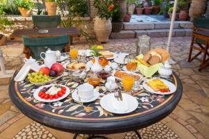 a table with a breakfast of eggs and fruit on it at Nostos Hotel in Galaxidhion