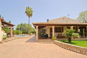 a house with a patio and a swimming pool at Villa Es Pou in El Port de la Selva