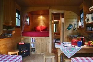 a small kitchen with a bed in a tiny house at La Maison de l'Omignon in Vermand +24 photos