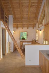 a large kitchen with wooden ceilings and a staircase at Chalet Brenta Dolomites in Madonna di Campiglio