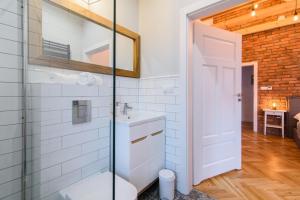 a bathroom with a toilet and a glass shower at Apartamenty Rydzewo in Rydzewo +104 photos