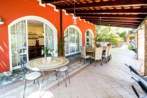 an outdoor patio with a table and chairs at Villa Lisa in Diano Marina