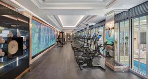 a gym with a row of treadmills and exercise bikes at Four Seasons Hotel George V Paris in Paris