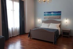 ein Schlafzimmer mit einem Bett und einem großen Fenster in der Unterkunft Case Vacanze Al Duomo in Licata