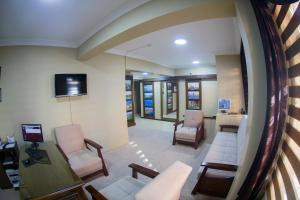 a living room with a couch and chairs and a tv at Ramparts Hotel in Istanbul