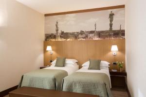 Postel nebo postele na pokoji v ubytování Starhotels Ritz