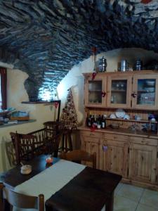 a kitchen with a dining table and a christmas tree at Affittacamere Chez Magan in Gignod