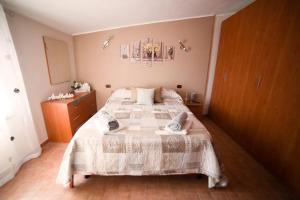 a bedroom with a large bed with a white blanket at Ambrosia in Pozzilli