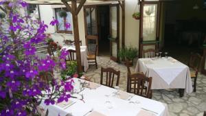 a restaurant with two tables and purple flowers at LAE' affittacamere in Roccamontepiano +35 photos