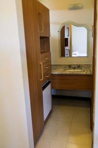 a bathroom with a sink and a mirror at Happy Hotel Girassol in Porto Seguro