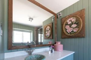 a bathroom with a sink and a mirror at The Frogmill Hotel in Cheltenham