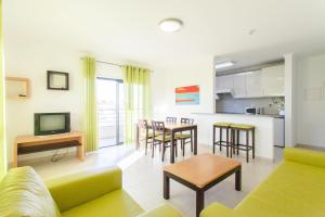 a living room with a couch and a table at Areias da Rocha by amcf in Portim&atilde;o