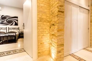 a stone wall in the hallway of a bedroom at B&B Villa Ida Pescara Centro in Pescara