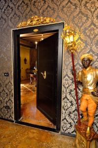 a gold statue of a man standing next to a door at Ai Cherubini in Venice