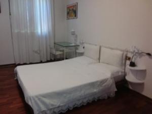 バニャカヴァッロにあるB&B Danyのベッドルーム(白いベッド1台、テーブル付)