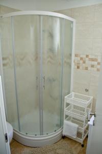 a shower with a glass door in a bathroom at Apartmani Žorić in Punat +23 photos