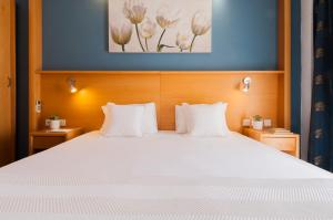 Letto o letti in una camera di Alexandra Hotel