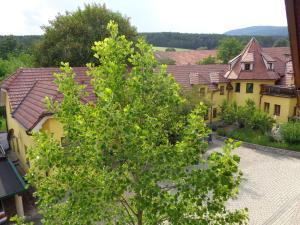 Pension Himmelreich في Ternitz: شجرة امام مجموعة منازل