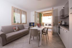 a living room with a couch and a table at Luxury apartment Garda Lake in Desenzano del Garda