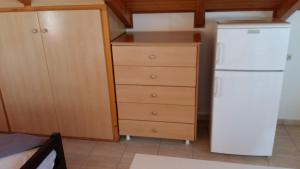 a kitchen with a white refrigerator and a dresser at Natalya in Lixouri