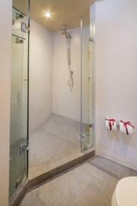 a shower with a glass shower stall in a bathroom at Suites Contempo in Mexico City