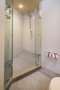 a shower with a glass shower stall in a bathroom at Suites Contempo in Mexico City +62 photos