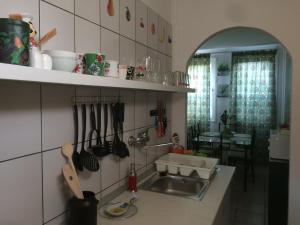 a kitchen with a sink and a counter with utensils at Ifjúság Nyaraló in Poroszló