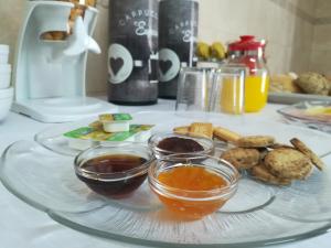 a plate of food with dipping sauces on a table at Casa Serra da Lapa in Viseu