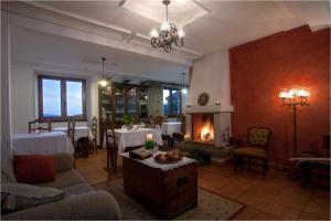 a living room with a table and a fireplace at Hotel Rural Casa Fontequeiroso in Muxia