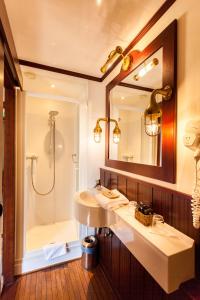 a bathroom with a sink and a shower at Boat Hotel De Barge in Bruges