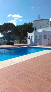 a swimming pool in front of a white house at Villa 38 in Casares