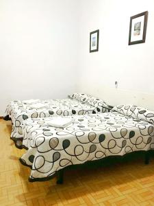 A bed or beds in a room at Hostal Los Arcos