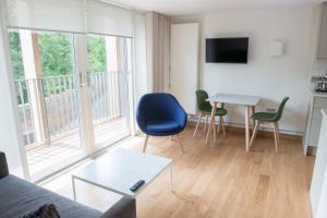 a living room with a couch and a table with chairs at West Court- Jesus College in Cambridge