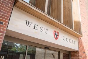a sign on the front of a west court building at West Court- Jesus College in Cambridge
