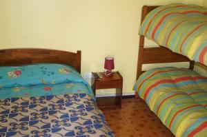Ένα ή περισσότερα κρεβάτια σε δωμάτιο στο Hostal Intipara