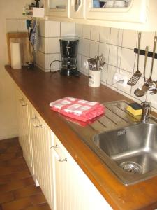 a kitchen counter top with a sink and a counter top at Kallmuth Cottage in Kallmuth