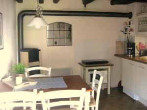 a kitchen and dining room with a table and chairs at Kallmuth Cottage in Kallmuth