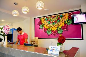 a man standing at a counter in a store at Mandala Hotel in Encarnación