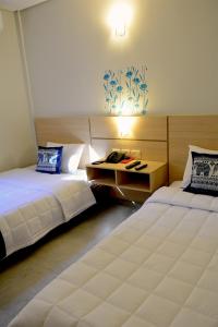 Letto o letti in una camera di Mandala Hotel