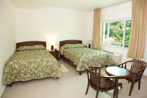 מיטה או מיטות בחדר ב-Simpson Bay Suites