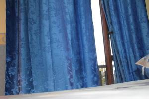 Postel nebo postele na pokoji v ubytování Hotel Diana