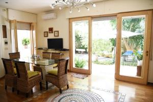 a dining room with a table and chairs and a television at B&B Al Vecchio Glicine in Torre Canne