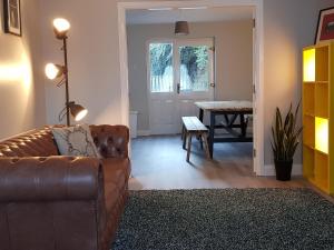 a living room with a couch and a table at Spire View Townhouse in Ballycastle