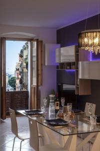 a kitchen with a table with chairs and a dining room at La Casa nel Corso in Cagliari