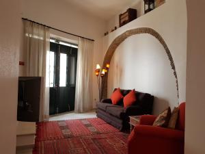 a living room with a couch and a window at Casa Da Ponte in Estói