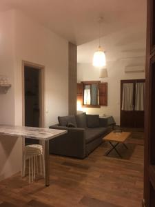 a living room with a couch and a table at Apocalypsis Houses in Skala