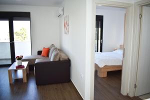 a living room with a couch and a bed at Apartment L'ideal in Ulcinj +31 photos