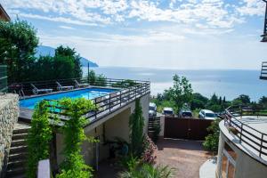 a view from the balcony of a house with a swimming pool at Priliv Прилив in Gurzuf
