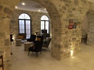 a room with a stone wall with chairs and tables at Agriturismo Paradiso 44 in Assisi